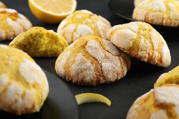 Delicious lemon cookies on black table, closeup