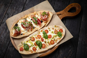 delicious pizza with cheese, greens, sauce in a restaurant
