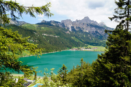 scenic emerald-green alpine lake Haldensee surrounded by lush green trees in the Alps of the Tannheim valley or Tannheimer Tal, Tirol, Austria