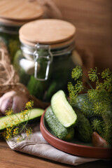 Fresh cucumbers and other ingredients prepared for canning on wooden table