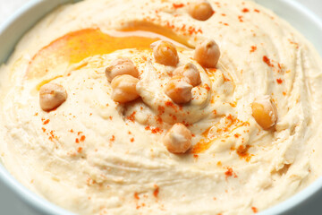 Tasty hummus with garnish in bowl, closeup