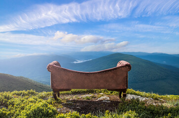 relaxation in nature. a classic sofa on top of a mountain against the background of a mountain...