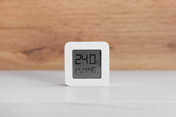 Digital hygrometer with thermometer on white table