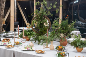 Place table setting for Christmas white table with decor elements with green branches Christmas tree