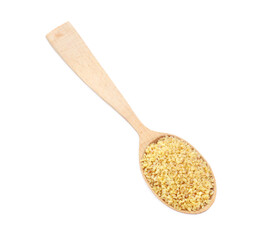 Wooden spoon with uncooked bulgur isolated on white, top view