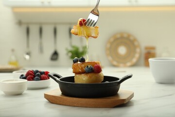 Delicious cottage cheese pancakes with fresh berries and honey served on white table