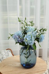 Beautiful blue hortensia flowers in vase on table indoors