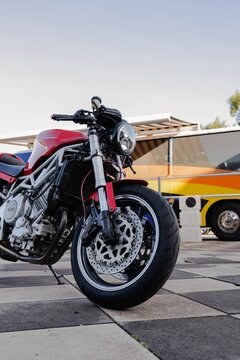 Vertical shot of a luxurious red motorcycle ready for racing at the TT Circuit Assen, Netherlands