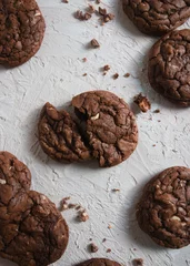Foto op Plexiglas Vertical shot of chocolate cookies with nuts on the table © Inna Prigodich/Wirestock Creators