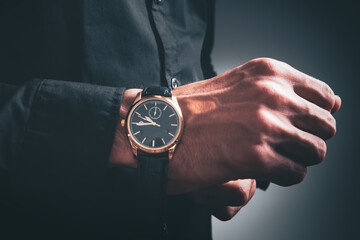 young man puts on a wristwatch