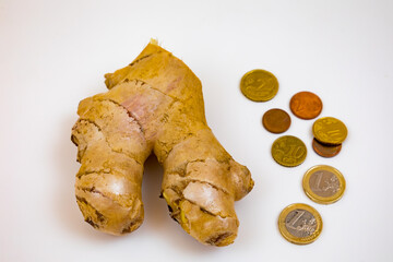 Piece of ginger and euro coins on a white background