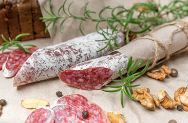 Still life of salami sausage with bread and nuts. Tasty food.