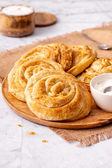 Close up of the traditional rolled vegetarian pie for breakfast on a marble table in rustic style 