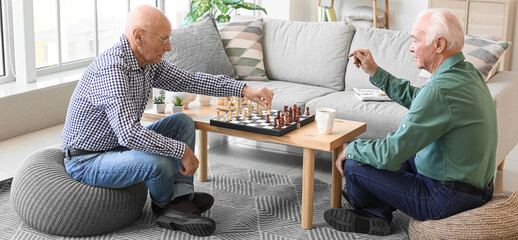 Elderly men playing chess at home