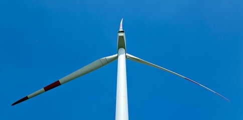 wind power plant in blue sky with symmetric blades