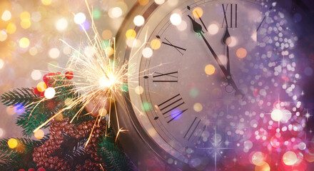 Festive collage of clock, Christmas sparkler and blurred lights. New Year celebration