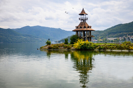 Danubian landscape. Old lighthouse, building on the bank of the Danube. Autumn on the Danube. Reflections in the water.