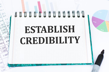 ESTABLISH CREDIBILITY. text on an open notebook