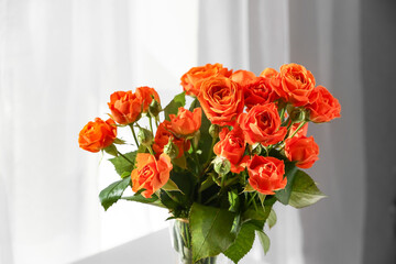 Bouquet of fresh roses in room, closeup