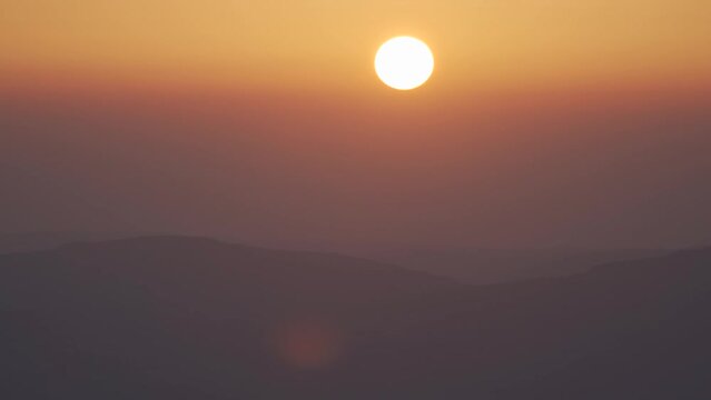 Misty mountain sunrise timelapse through wet humid air