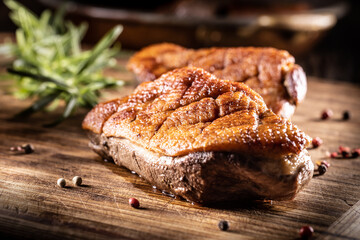 Roasted duck breast on a cutting board ready for slicing and serving