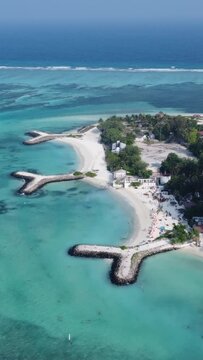 Amazing drone view of the Maldives beach and water with beautiful colors. Vertical video.