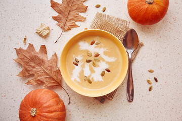 Vegan healthy autumn pumpkin creame-soup with plant-based cream and seeds. Autumn cuisine