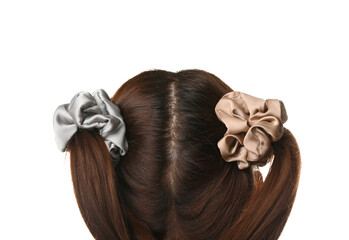 Woman with ponytails and different silk scrunchies on white background, closeup