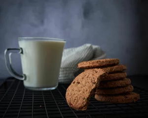 Keuken foto achterwand Chocolate cookies and cup of milk © Milos Maric/Wirestock Creators