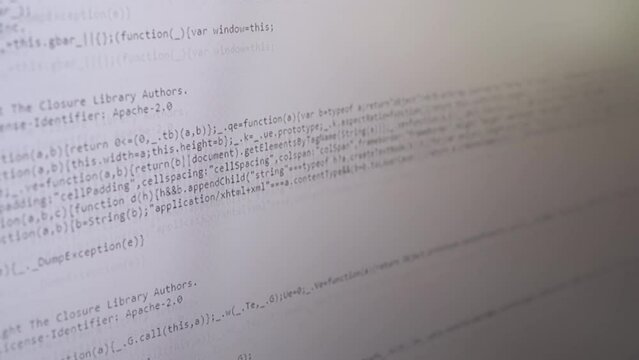 Programmer Views the HTML Code of the Page on a Screen of a Computer Monitor. Code scrolling. Study, analysis of a web page, site. Signs, symbols, numbers, words. Software. White abstract background.