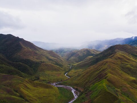 Fototapeta Landscape of a road through green hills in Bukidnon, Philippines.