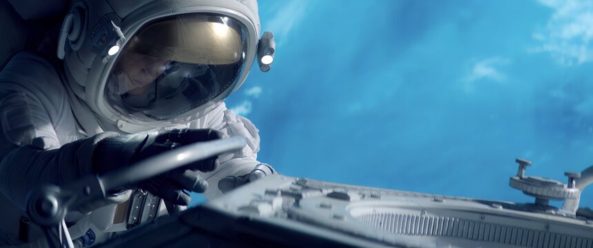 Portrait of female astronaut performing spacewalk, working on a outer part of a space craft. Space exploration, Mars mission