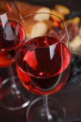 Fotobehang Glasses of delicious rose wine on table, closeup © New Africa