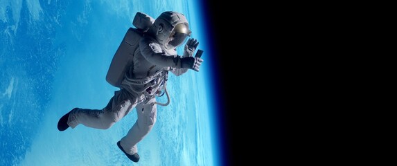 Female astronaut having a video call on her phone while performing space walk in open space, Earth...