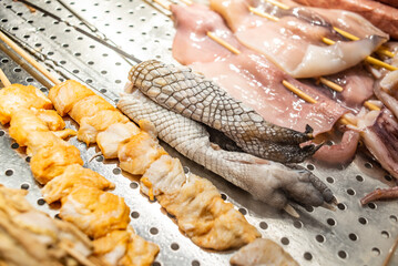 Crocodile claws on a food street BBQ stall