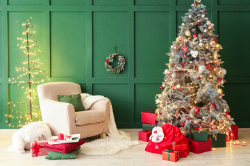 Interior of living room with Santa bag, armchair and Christmas tree
