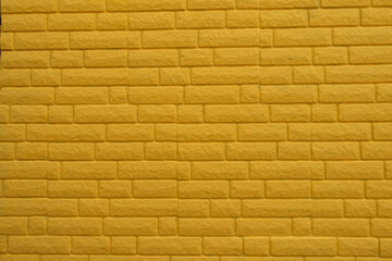 Background - bright yellow painted brick veneer wall texture