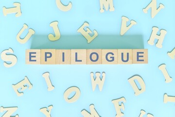 Epilogue part of a book concept. Wooden blocks typography word flat lay in blue background	