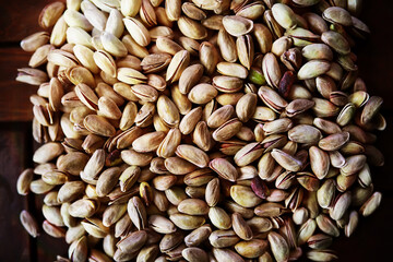 Roasted salted pistachios. Dried pistachios in small sack on  table.