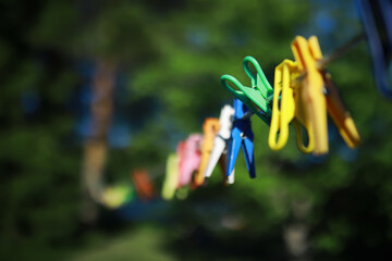 old pegs on a rope. One old retro clothespin wooden on a linen rope. Work on the house, washing, drying linen.