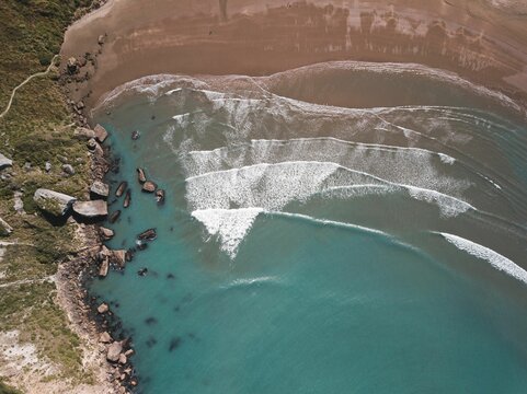 View of turquoise water and sandy shore. Castlepoint, New Zealand.