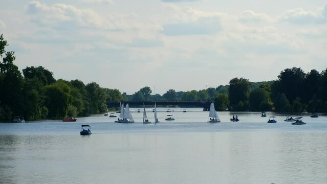 Yachts and catamarans sail on Lake Aasee near the yacht club.