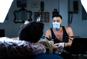 Laid back tattoist working on his new masterpice.