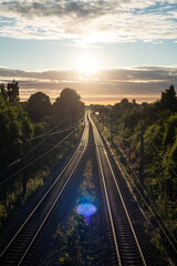 traintracks during sunset with lens flare