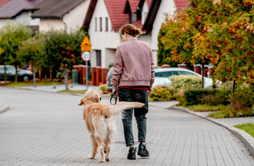 Girl and golden retriever dog
