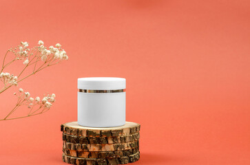 White jar with moisturizing cream on a wooden podium