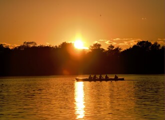 Orange sunset by the lake with rovers and sun