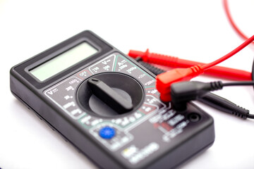 Digital multimeter and probes on white background