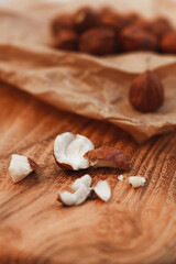 Cracked hazelnut on wooden table close up