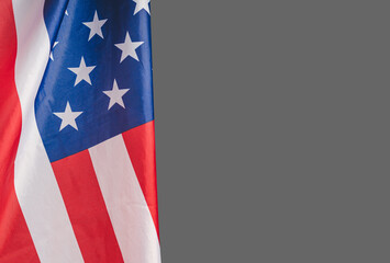 The American flag against a gray background with copy space for text